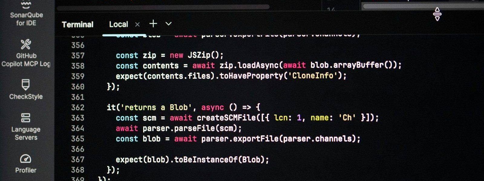Coding on a dark theme computer screen